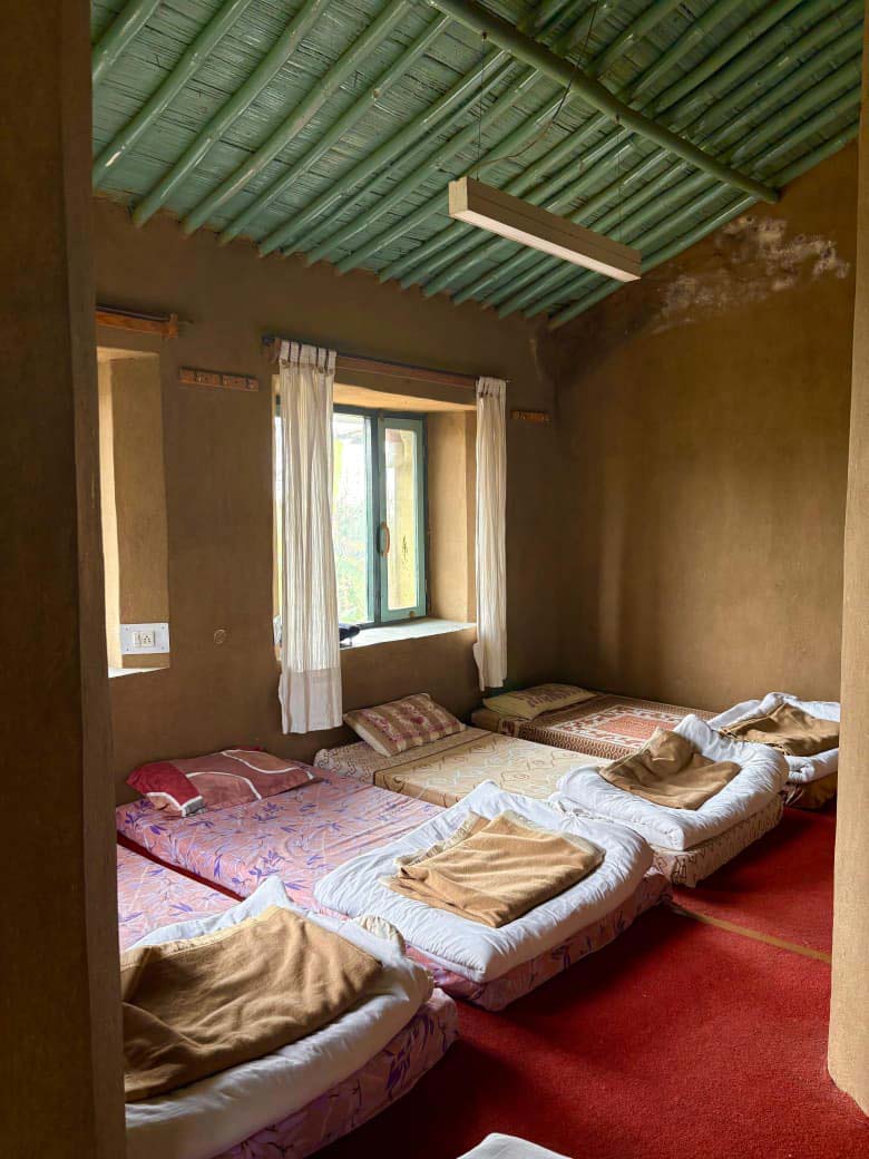Outdoor discussion circle at Sambhaavnaa with Dhauladhar mountains in the background